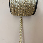 Gold zigzag lace trim measured with ruler showing approx 1cm width