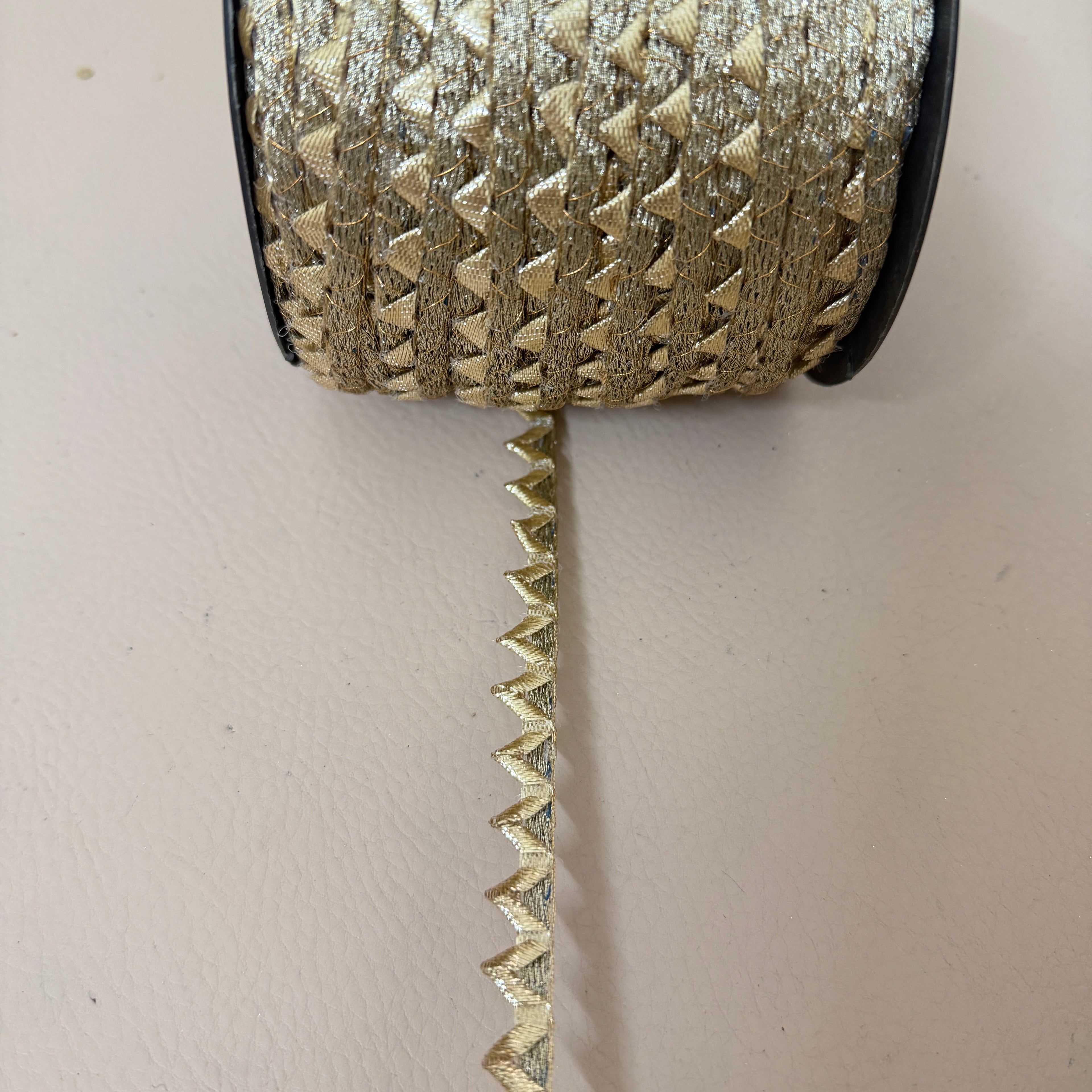 Gold zigzag lace trim measured with ruler showing approx 1cm width