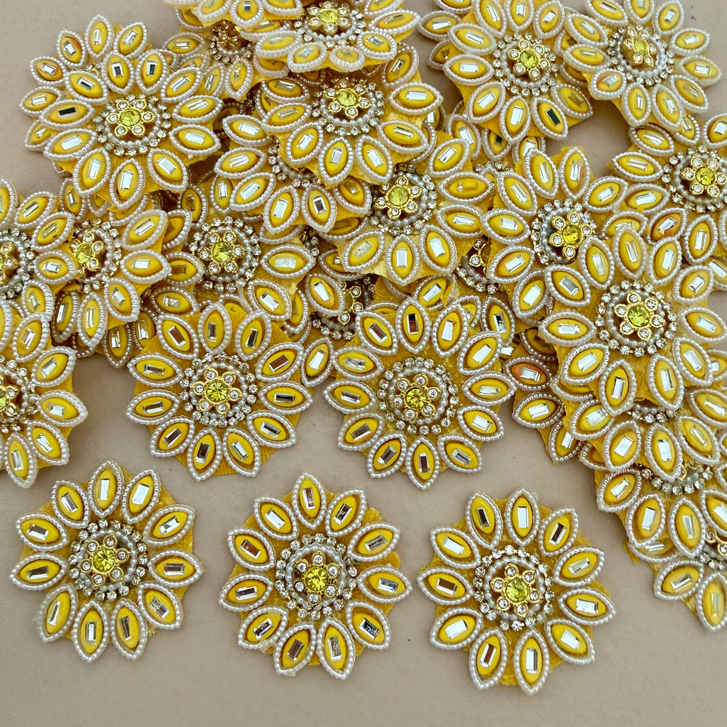 Close-up of multiple yellow floral rhinestone patches
