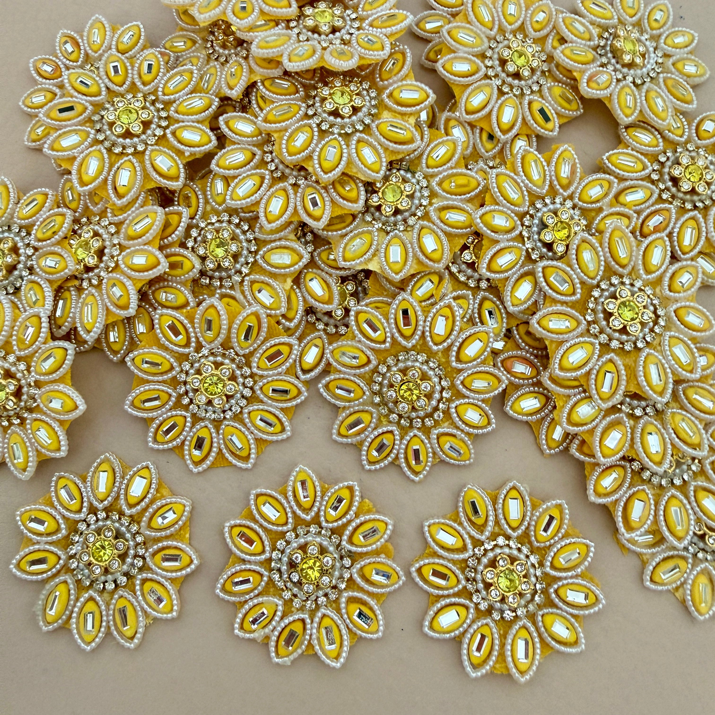 Close-up of multiple yellow floral rhinestone patches