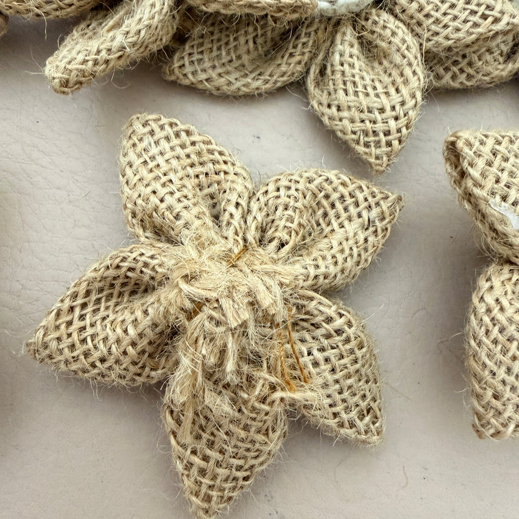 Close-up of jute burlap flower patch showing white crochet centre detail