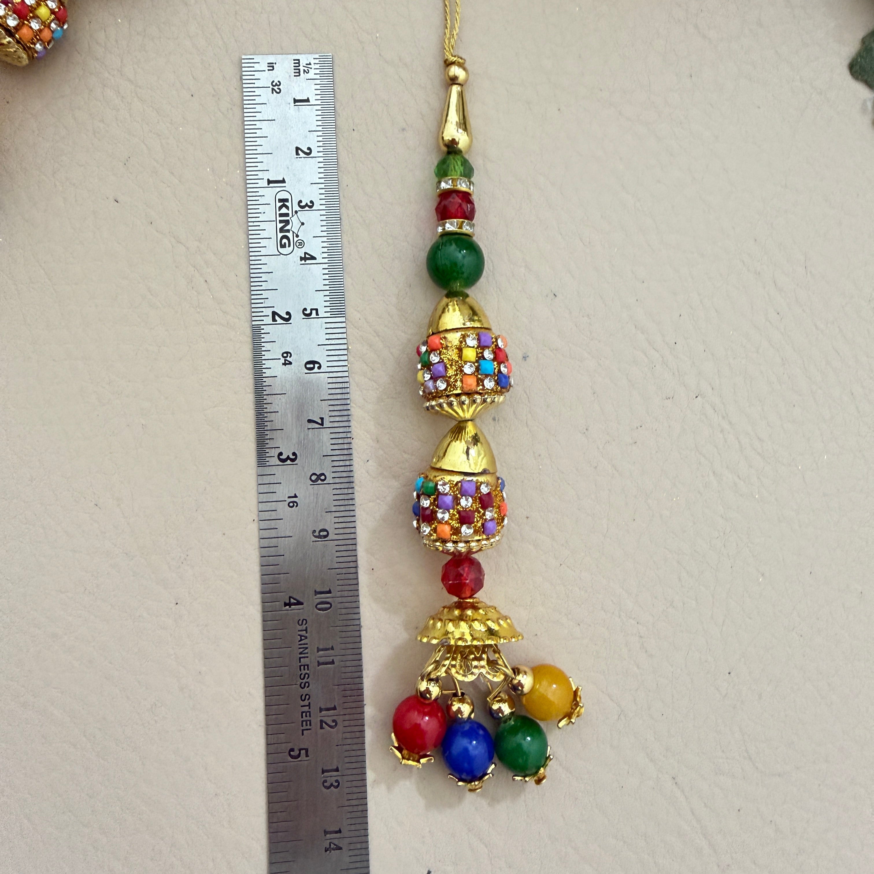 Two multicolour jhumka latkans side by side showing full detail